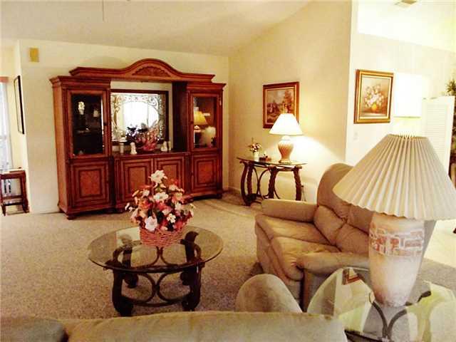6940 Southeast Lillian Court Stuart, FL 34997 - Photo 5 of 25 a living room with furniture and a chandelier