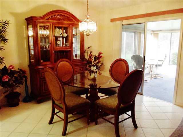 6940 Southeast Lillian Court Stuart, FL 34997 - Photo 7 of 25 a view of a dining room with furniture and chandelier