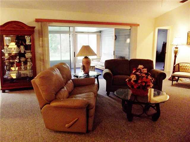 6940 Southeast Lillian Court Stuart, FL 34997 - Photo 8 of 25 a living room with furniture and a large window