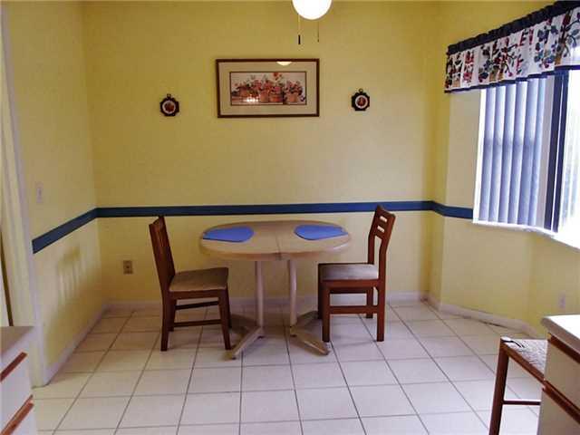 6940 Southeast Lillian Court Stuart, FL 34997 - Photo 10 of 25 a view of a chair and table in a balcony