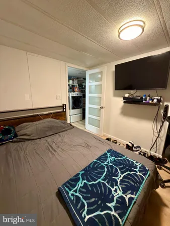 a bedroom with a bed and a flat screen tv