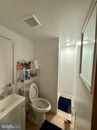 a bathroom with a sink toilet and a mirror