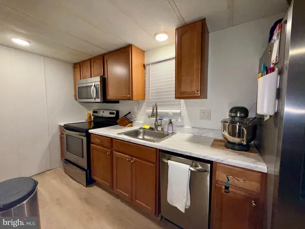 a kitchen with a sink cabinets and appliances