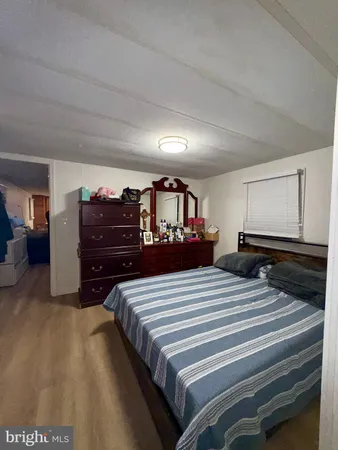 a bedroom with bed and a large mirror