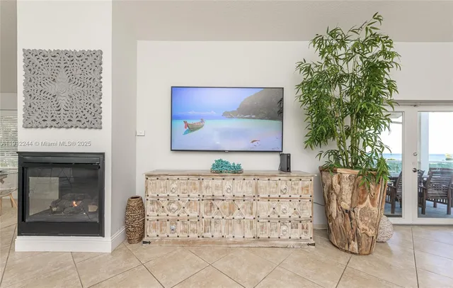 a living room with furniture a fireplace and a table