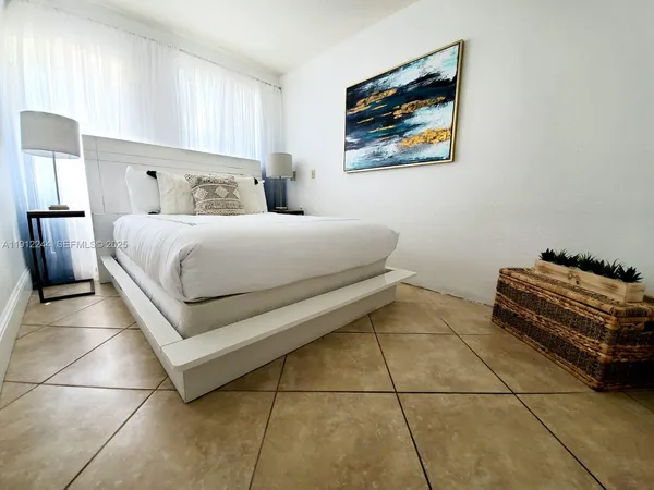 a bed room with a bed and a large window