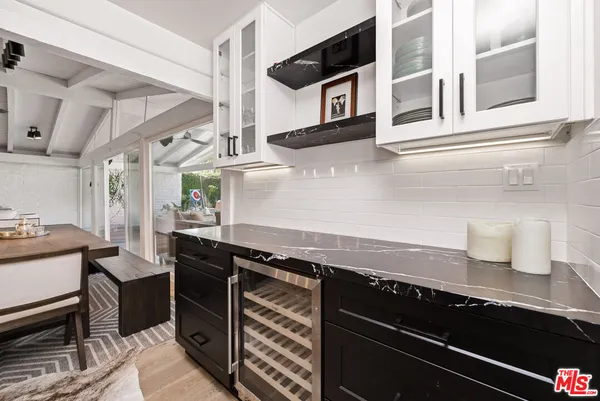 a kitchen with stainless steel appliances granite countertop a sink and a stove