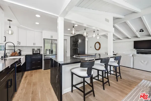 a kitchen with a sink and wooden cabinets