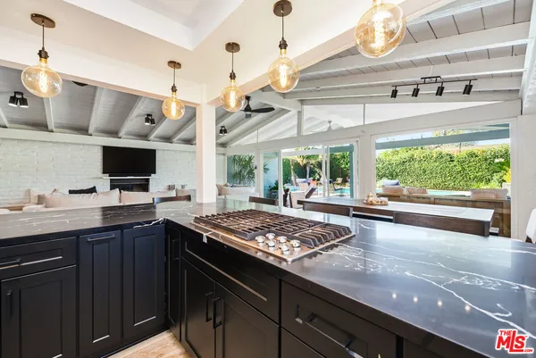 a living room with furniture a fireplace and a floor to ceiling window