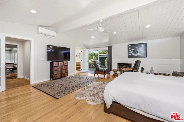 a bedroom with bed and a large window