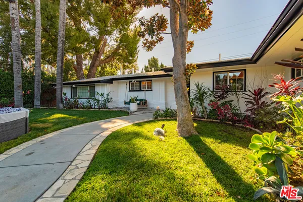 a view of a house with swimming pool yard and patio