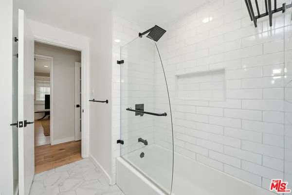 a view of a tennis ground with large trees