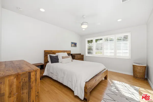 a view of a swimming pool with a garden and trees