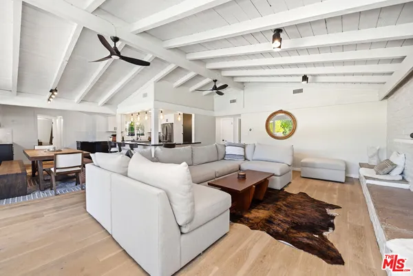 a living room with a couch and a clock on the dresser