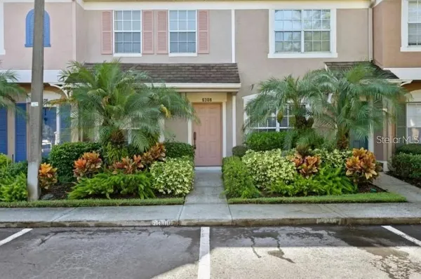 front view of a brick house with a yard