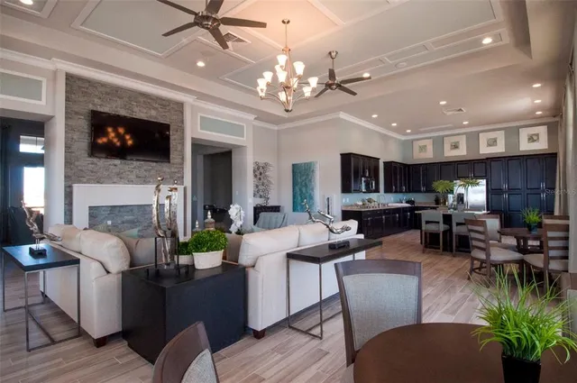 a living room with furniture a fireplace and a chandelier