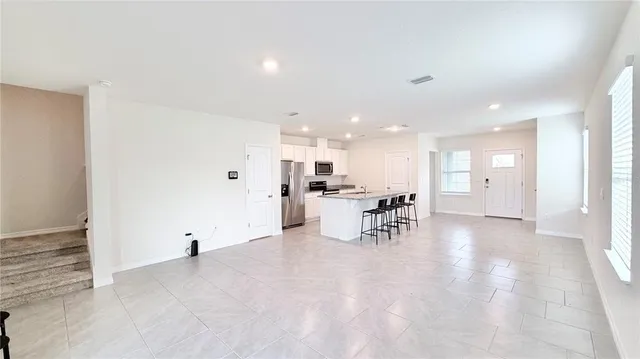 a view of a kitchen with dining table and chairs