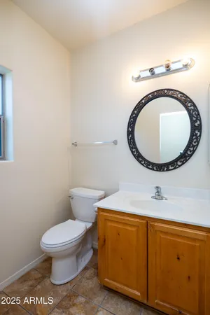 a bathroom with a sink a toilet and a mirror