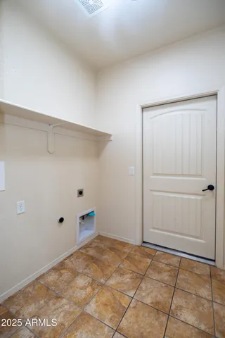 a view of a room with a ceiling fan and a window