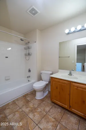 a view of a room with a ceiling fan and a window