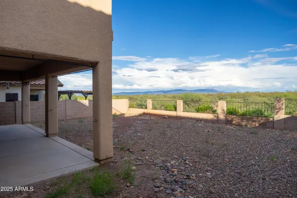 a view of a house with a yard and large tree