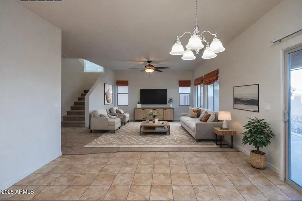a living room with furniture a large window and a flat screen tv