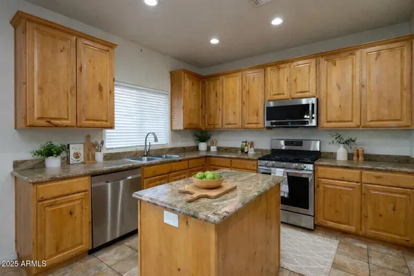a kitchen with a sink stove top oven and cabinets