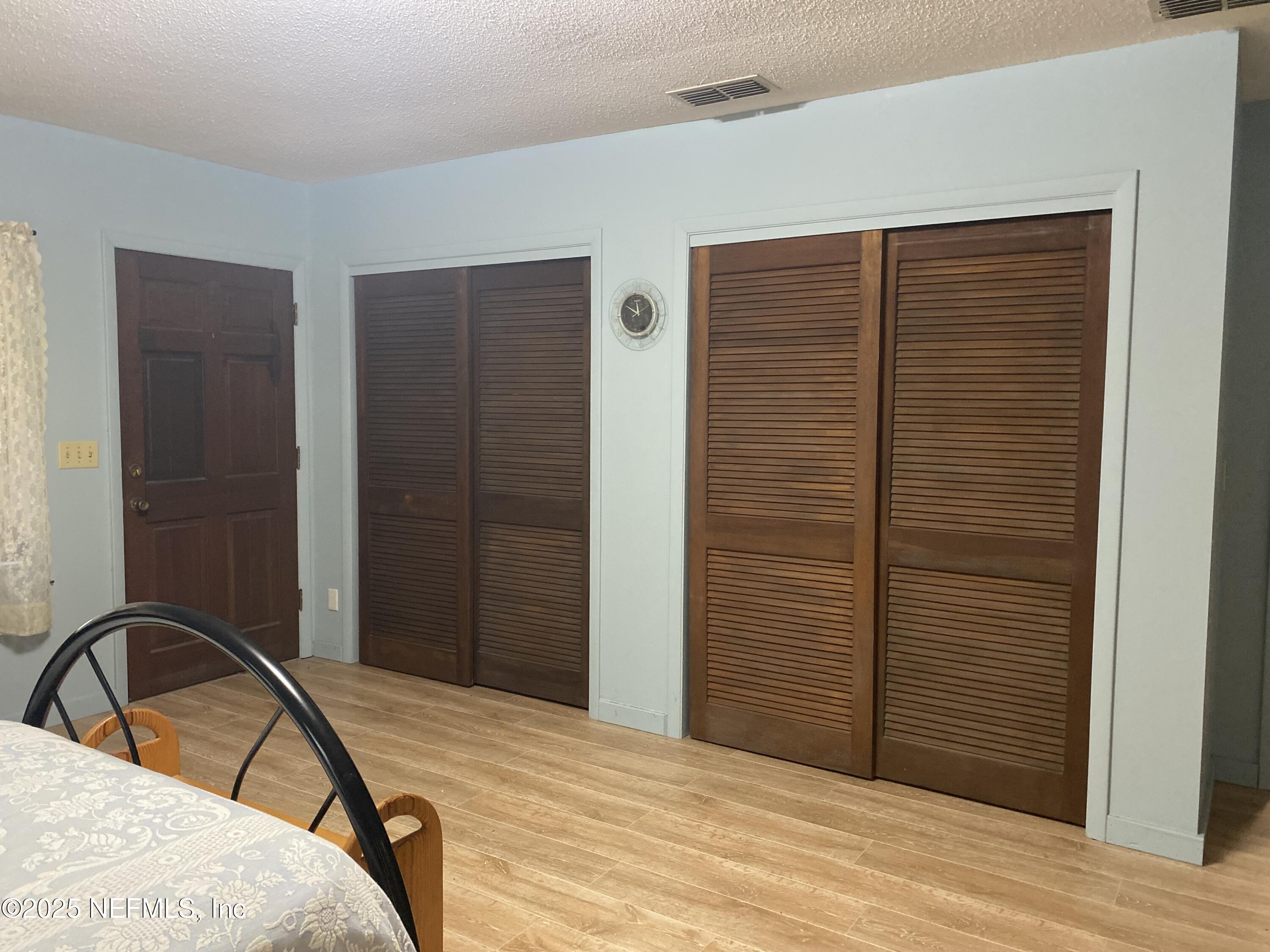 8093 Breezy Point Road East Keystone Heights, FL 32656 - Photo 13 of 35 a bedroom with a bed and a dresser