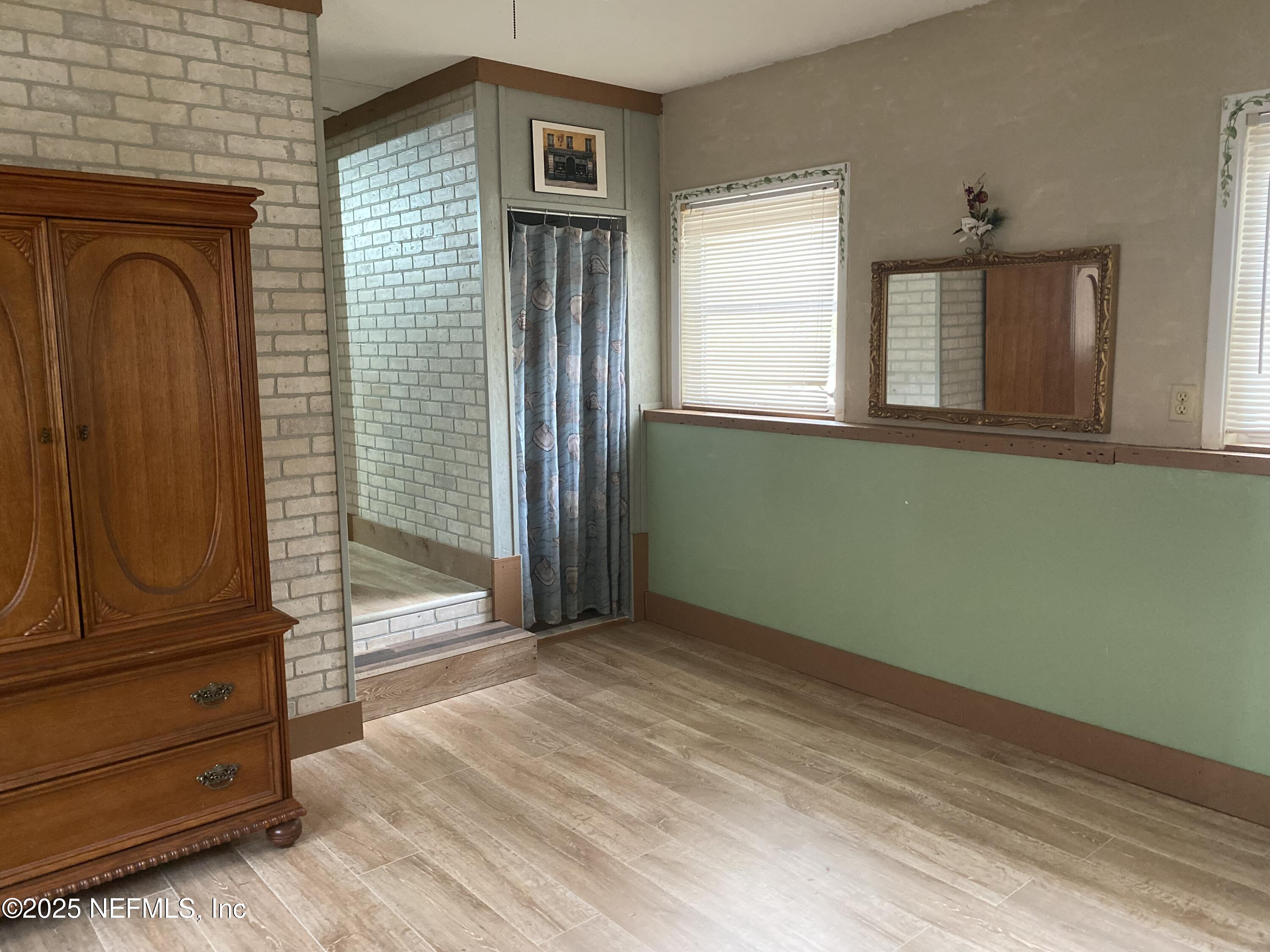8093 Breezy Point Road East Keystone Heights, FL 32656 - Photo 32 of 35 a view of empty room with wooden floor and fan