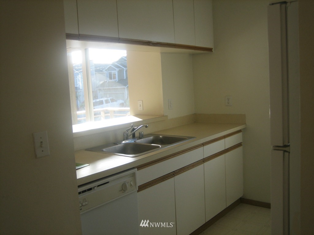 703 North 95th Street Seattle, WA 98103 - Photo 8 of 11 a bathroom with a sink and a window