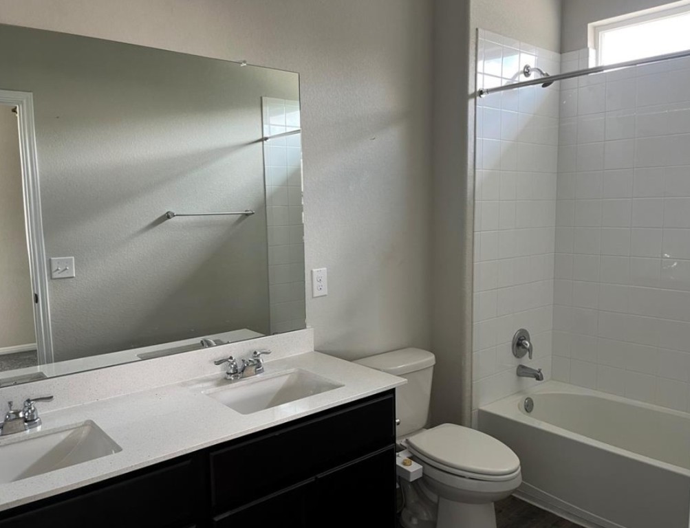 14110 Luisium View, Unit 72 Pflugerville, TX 78660 - Photo 12 of 21 a bathroom with a sink a toilet and shower