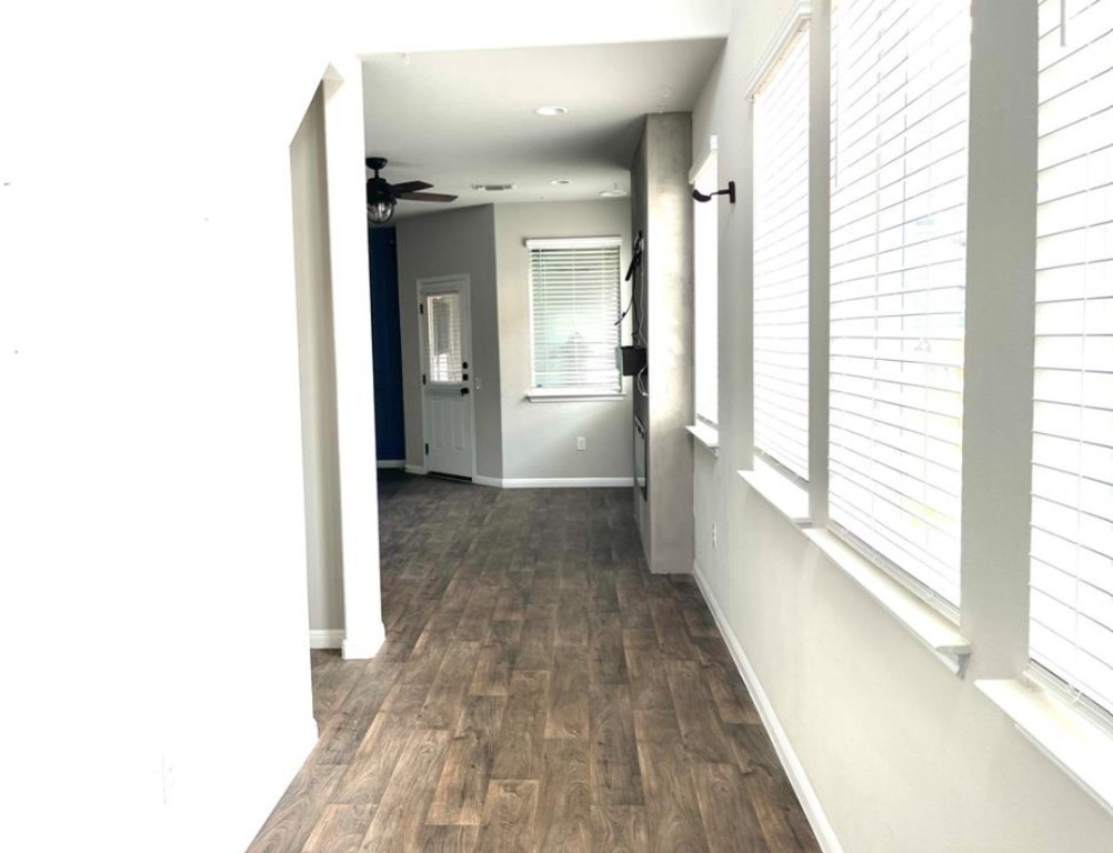14110 Luisium View, Unit 72 Pflugerville, TX 78660 - Photo 2 of 21 a view of a hallway with wooden floor and windows