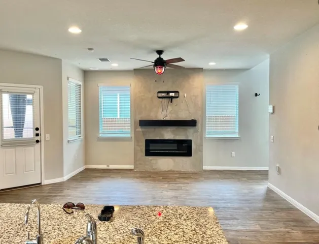 an empty room with windows and fireplace
