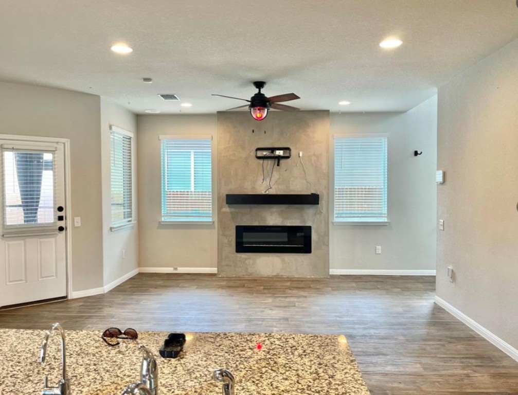 14110 Luisium View, Unit 72 Pflugerville, TX 78660 - Photo 3 of 21 an empty room with windows and fireplace