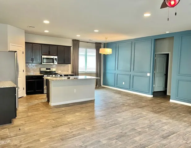 a large kitchen with cabinets and stainless steel appliances