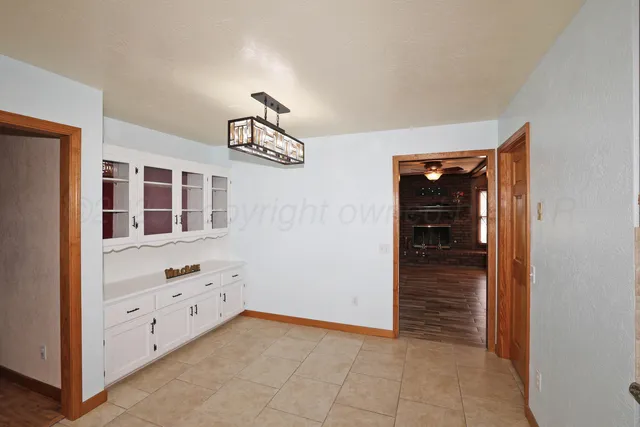 a kitchen with granite countertop a refrigerator a stove top oven a sink and dishwasher