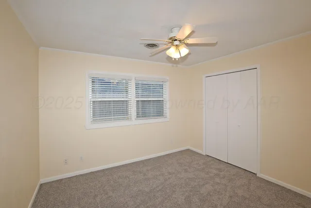 an empty room with a fan and a fan