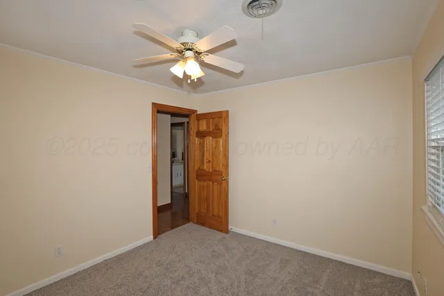 a view of a hallway with a window and a chandelier