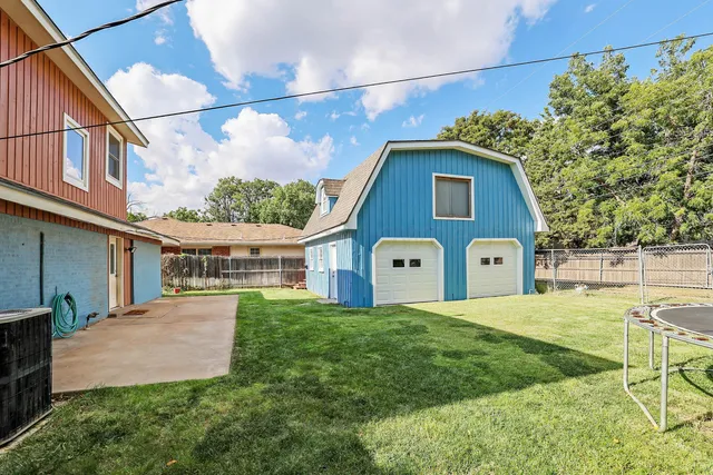 a backyard of a house with table and chairs