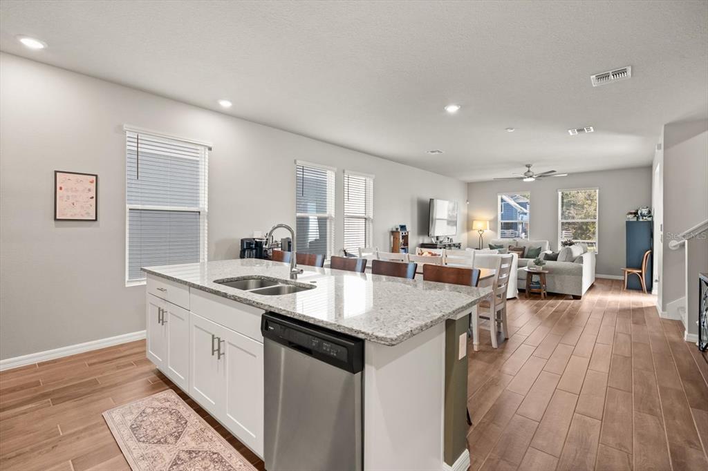 140 South Zuni Road St. Cloud, FL 34771 - Photo 13 of 35 a open kitchen with stainless steel appliances granite countertop a lot of counter space and wooden floor