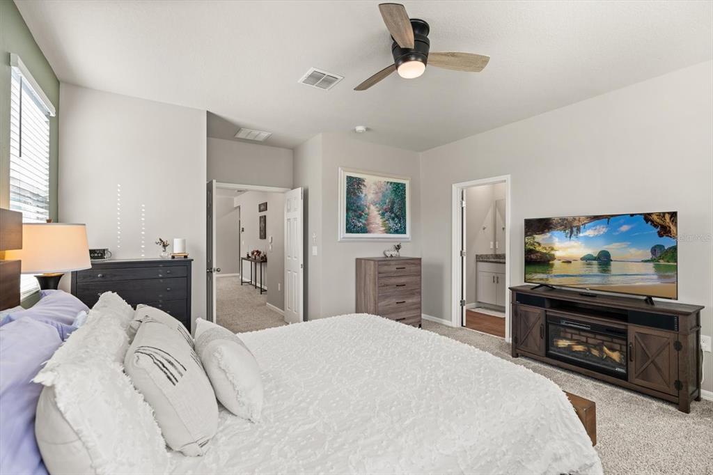 140 South Zuni Road St. Cloud, FL 34771 - Photo 18 of 35 a bedroom with a bed and a flat screen tv