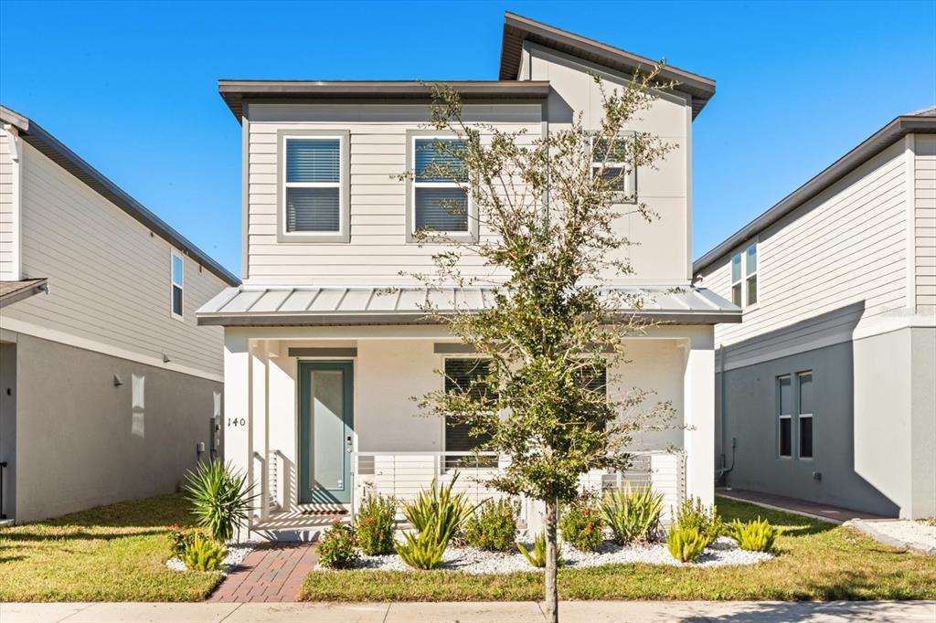 140 South Zuni Road St. Cloud, FL 34771 - Photo 2 of 35 a front view of a house with garden