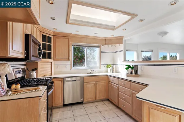 a kitchen with a sink window and cabinets