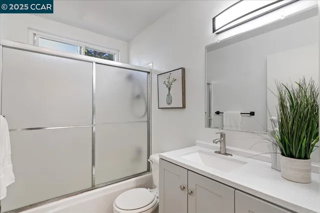 a bedroom with a bed and a potted plant