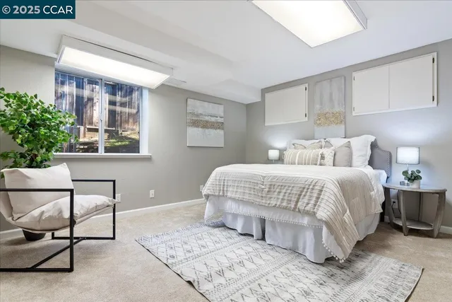 a bedroom with a bed and a painting on the wall