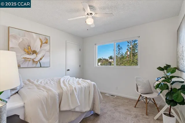 a bedroom with a bed and a potted plant