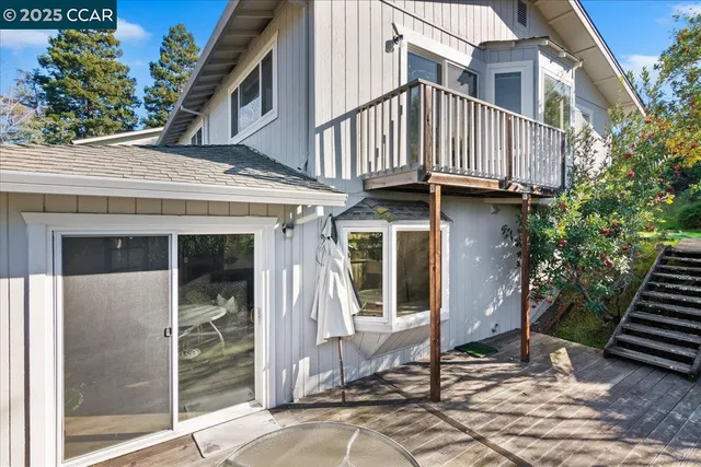 a view of a patio with a table chairs and backyard