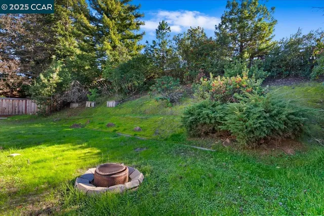 a backyard of a house with table and chairs