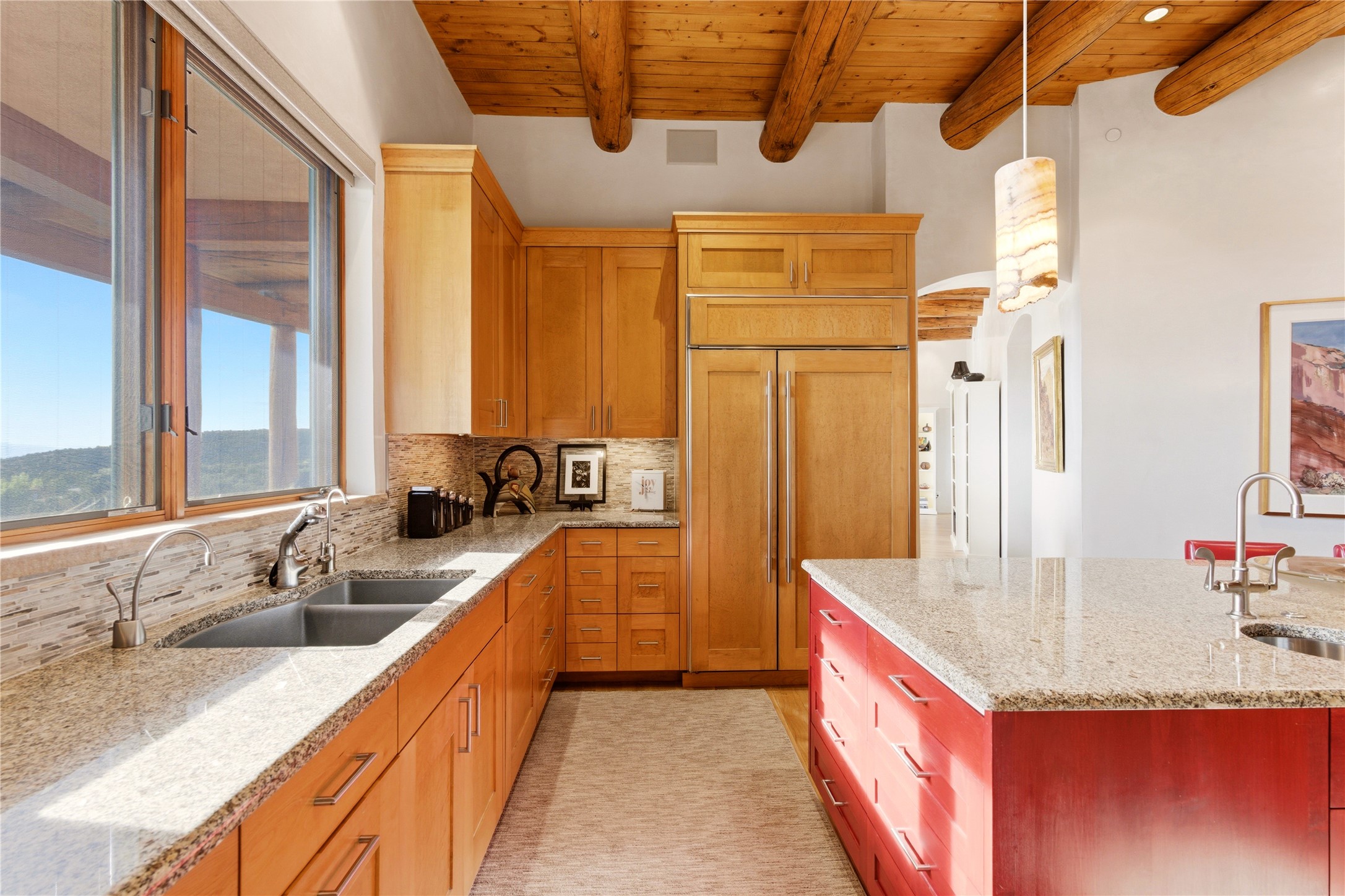 1008 South Summit Ridge Santa Fe, NM 87501 - Photo 18 of 42 Kitchen sink with Panoramic Windows to take in the view. Paneled Sub-Zero Refrigerator