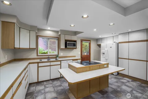a kitchen with stainless steel appliances granite countertop a sink and a stove